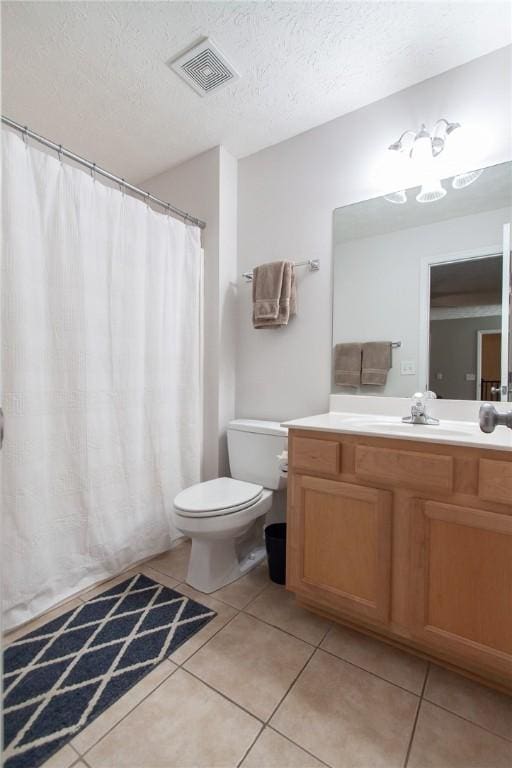 303 N Ross Ave Unit 215, Auburn, AL 36830 - full bath with tile patterned flooring, vanity, and a textured ceiling