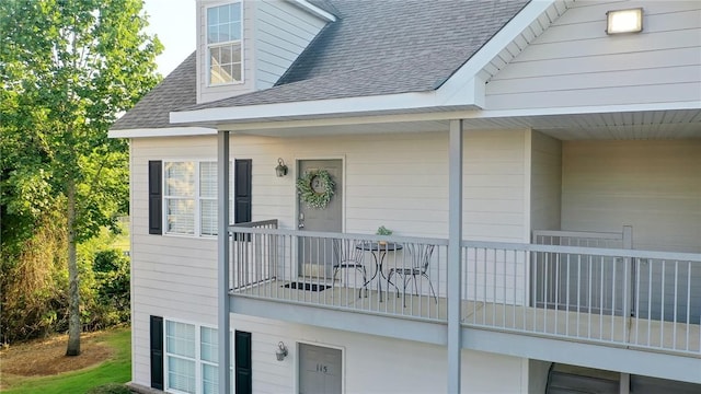 303 N Ross Ave Unit 215, Auburn, AL 36830 - view of exterior entry featuring a shingled roof and a balcony