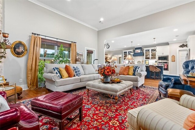 living room featuring hardwood / wood-style flooring and crown molding