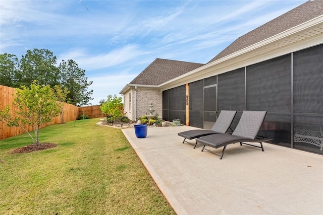 view of yard featuring a sunroom and a patio