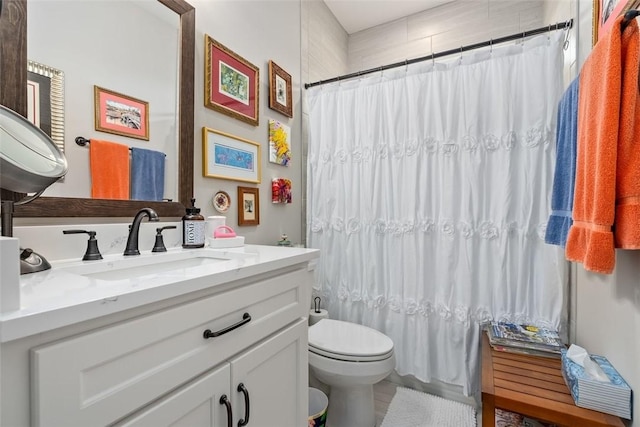 bathroom with a shower with shower curtain, vanity, and toilet