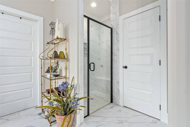 bathroom featuring a shower with shower door