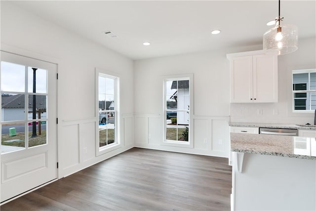 kitchen featuring white cabinetry, light stone counters, wood finished floors, and recessed lighting