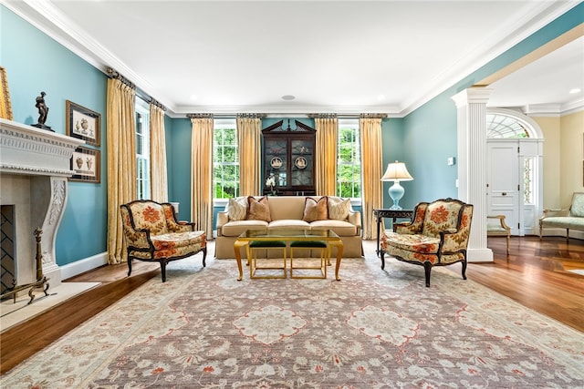 1601 Tanyard Rd, Lanett, AL 36863 - living room featuring healthy amount of natural light, wood finished floors, crown molding, ornate columns, and a high end fireplace
