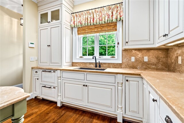 1601 Tanyard Rd, Lanett, AL 36863 - kitchen with white cabinetry, decorative backsplash, light countertops, dark wood-style flooring, and crown molding