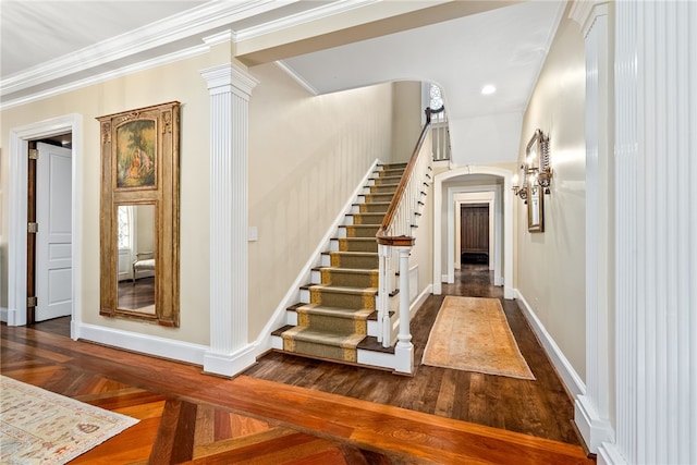 1601 Tanyard Rd, Lanett, AL 36863 - staircase featuring arched walkways, crown molding, wood finished floors, and ornate columns