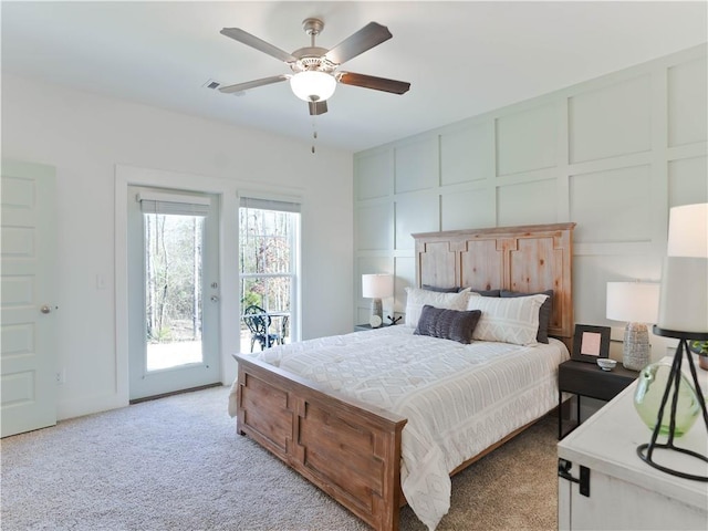 bedroom with multiple windows, access to outside, light carpet, and ceiling fan