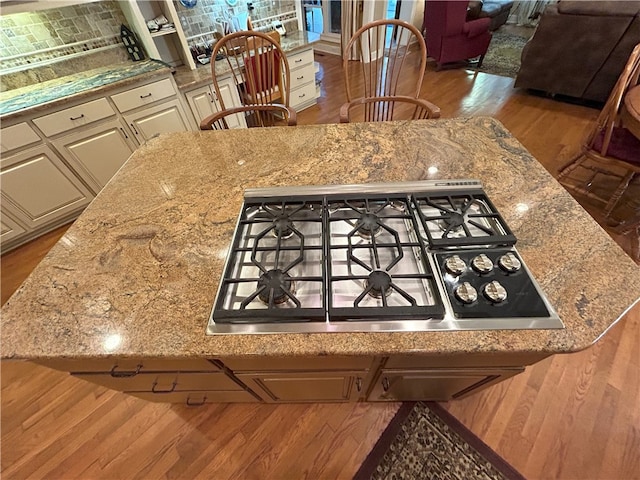 1894 Hillton Ct, Auburn, AL 36830 - interior details featuring stainless steel gas cooktop, wood finished floors, white cabinetry, and light stone countertops