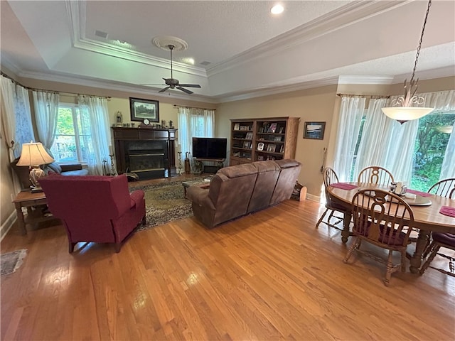 1894 Hillton Ct, Auburn, AL 36830 - living room with a tray ceiling, light wood-type flooring, a fireplace, and a ceiling fan