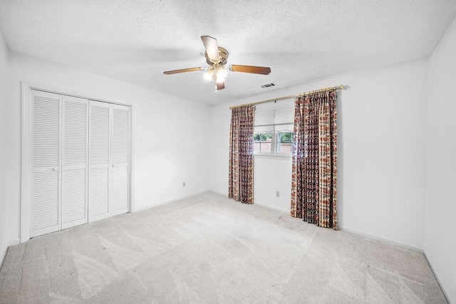 5004 22nd Ave, Phenix City, AL 36867 - unfurnished bedroom with carpet floors, a closet, a textured ceiling, and ceiling fan