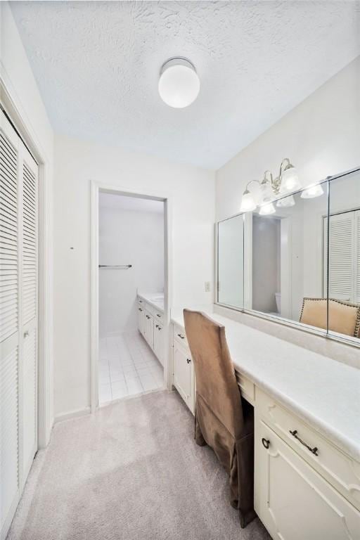 5004 22nd Ave, Phenix City, AL 36867 - bathroom with a closet, vanity, and a textured ceiling