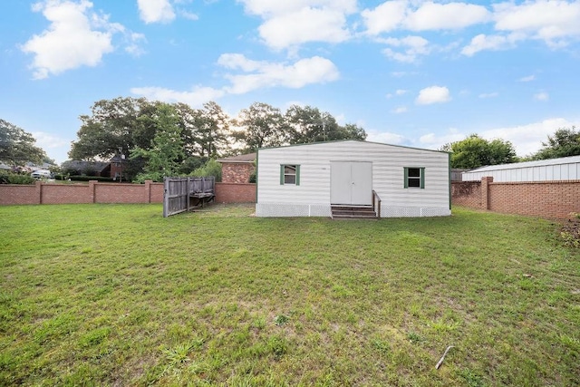 5004 22nd Ave, Phenix City, AL 36867 - rear view of property featuring entry steps, a fenced backyard, and an outbuilding