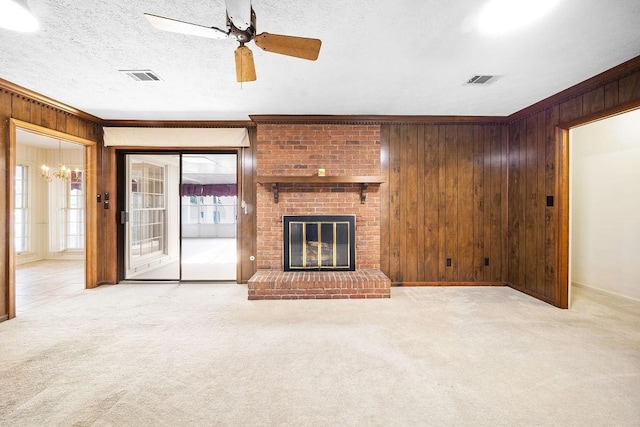 5004 22nd Ave, Phenix City, AL 36867 - unfurnished living room featuring wooden walls, a chandelier, carpet floors, ceiling fan, and ornamental molding