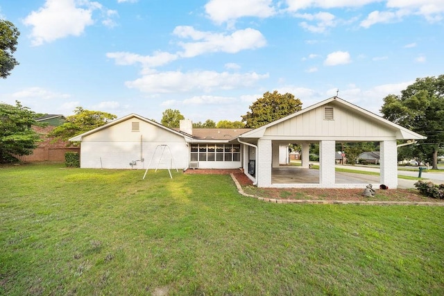 5004 22nd Ave, Phenix City, AL 36867 - back of house with a sunroom, brick siding, a carport, and a chimney