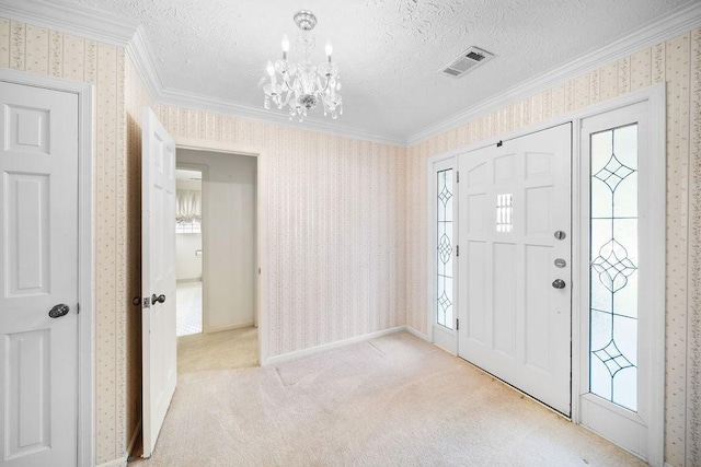 5004 22nd Ave, Phenix City, AL 36867 - entryway with ornamental molding, wallpapered walls, a chandelier, a textured ceiling, and light colored carpet