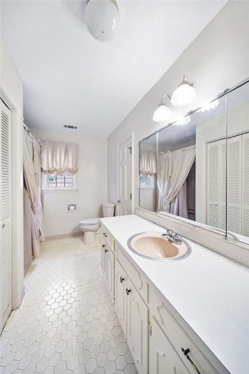 5004 22nd Ave, Phenix City, AL 36867 - full bath with a closet, vanity, and curtained shower