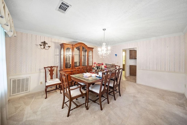 5004 22nd Ave, Phenix City, AL 36867 - dining space with a chandelier, wallpapered walls, light colored carpet, a wainscoted wall, and crown molding