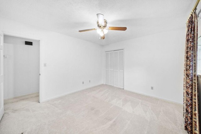 5004 22nd Ave, Phenix City, AL 36867 - unfurnished bedroom featuring carpet, a closet, a textured ceiling, and ceiling fan