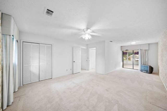 5004 22nd Ave, Phenix City, AL 36867 - unfurnished bedroom featuring a textured ceiling, carpet, and ceiling fan