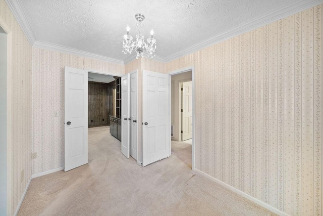 5004 22nd Ave, Phenix City, AL 36867 - empty room with a chandelier, ornamental molding, a textured ceiling, and carpet floors