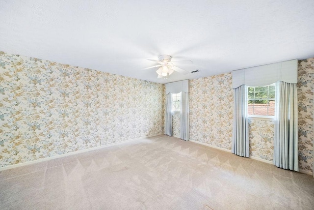 5004 22nd Ave, Phenix City, AL 36867 - carpeted spare room featuring wallpapered walls and ceiling fan