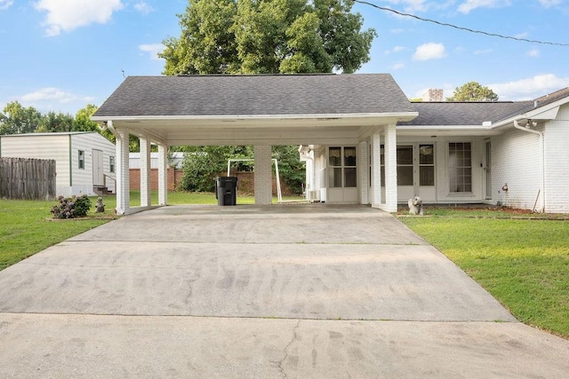 5004 22nd Ave, Phenix City, AL 36867 - view of front of house featuring brick siding, concrete driveway, an attached carport, roof with shingles, and a chimney