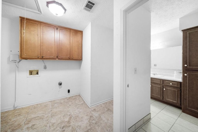 5004 22nd Ave, Phenix City, AL 36867 - laundry room with washer hookup, cabinet space, a textured ceiling, electric dryer hookup, and attic access