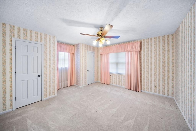 5004 22nd Ave, Phenix City, AL 36867 - unfurnished bedroom with wallpapered walls, a textured ceiling, carpet floors, and a ceiling fan
