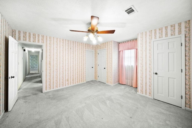 5004 22nd Ave, Phenix City, AL 36867 - unfurnished bedroom with wallpapered walls, carpet, and ceiling fan