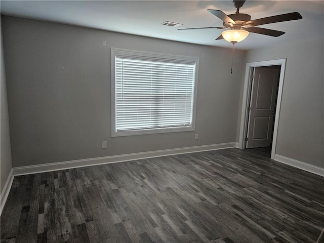 empty room featuring ceiling fan and dark wood-type flooring