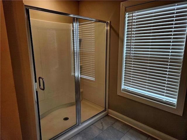 bathroom featuring a shower with door