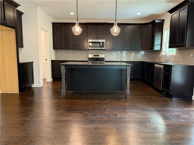 42 Lee Road 2234, Smiths Station, AL 36877 - kitchen with stainless steel appliances, dark wood-style floors, a center island, a breakfast bar area, and recessed lighting