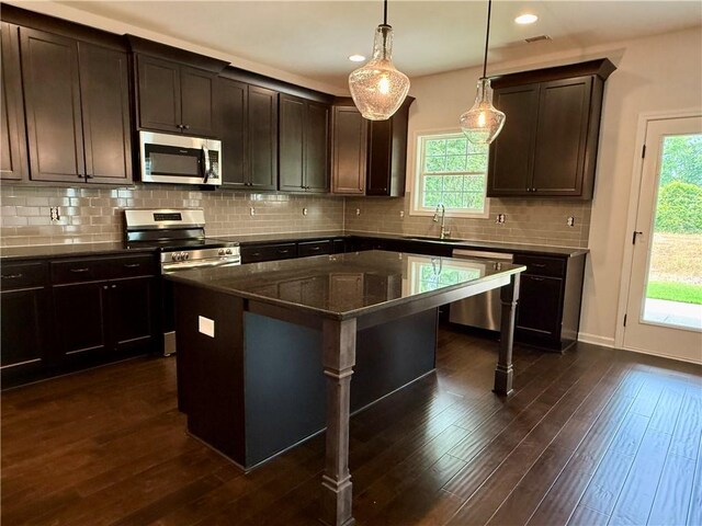 42 Lee Road 2234, Smiths Station, AL 36877 - kitchen featuring appliances with stainless steel finishes, a kitchen breakfast bar, healthy amount of natural light, dark wood finished floors, and recessed lighting