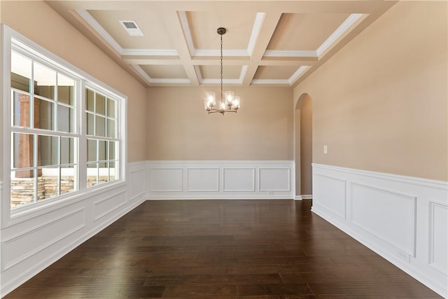 42 Lee Road 2234, Smiths Station, AL 36877 - unfurnished dining area featuring a chandelier, arched walkways, dark wood-style flooring, coffered ceiling, and a wainscoted wall