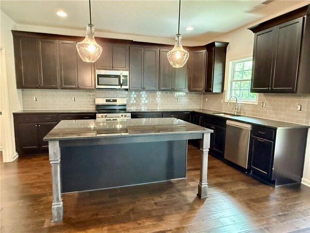 42 Lee Road 2234, Smiths Station, AL 36877 - kitchen featuring appliances with stainless steel finishes, a center island, dark brown cabinets, light stone countertops, and recessed lighting