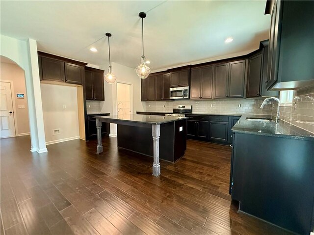 42 Lee Road 2234, Smiths Station, AL 36877 - kitchen featuring stainless steel appliances, arched walkways, a kitchen island, backsplash, and recessed lighting