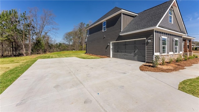 42 Lee Road 2234, Smiths Station, AL 36877 - view of home's exterior with board and batten siding, a yard, a shingled roof, and concrete driveway