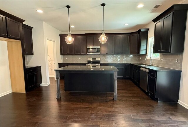 42 Lee Road 2234, Smiths Station, AL 36877 - kitchen featuring stainless steel appliances, dark countertops, dark wood-style floors, a center island, and recessed lighting