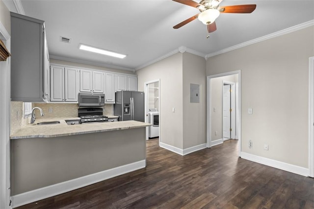 kitchen featuring crown molding, decorative backsplash, appliances with stainless steel finishes, dark wood-type flooring, and a sink