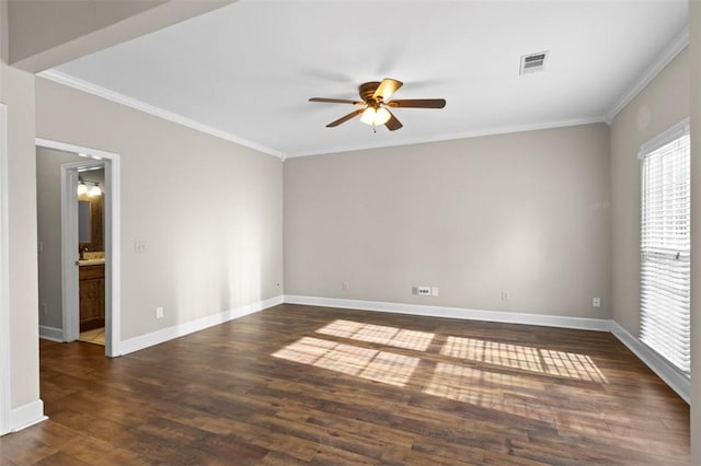 empty room with ornamental molding, dark wood-style flooring, and plenty of natural light