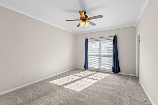 unfurnished room featuring light colored carpet, crown molding, and baseboards