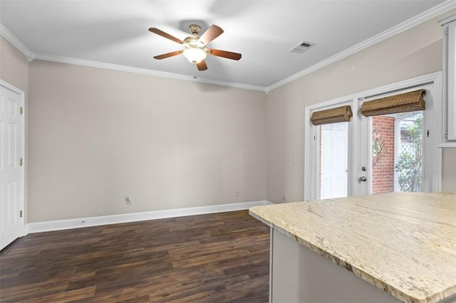 kitchen with dark wood-style flooring, visible vents, baseboards, light countertops, and ornamental molding