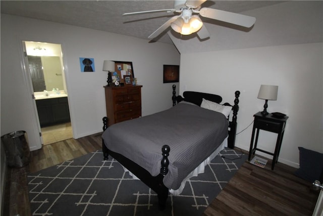 bedroom with a textured ceiling, ensuite bath, ceiling fan, and dark wood-type flooring