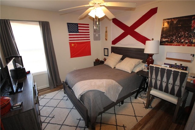 bedroom with ceiling fan and light wood-type flooring