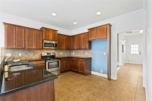 2514 Churchill Cir, Auburn, AL 36832 - kitchen with stainless steel appliances, a sink, dark stone counters, decorative backsplash, and light tile patterned floors