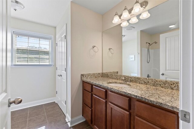2514 Churchill Cir, Auburn, AL 36832 - bathroom featuring tile patterned flooring, baseboards, vanity, and a shower