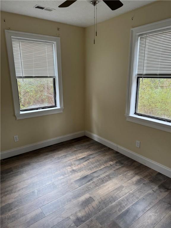 spare room featuring ceiling fan and dark hardwood / wood-style flooring