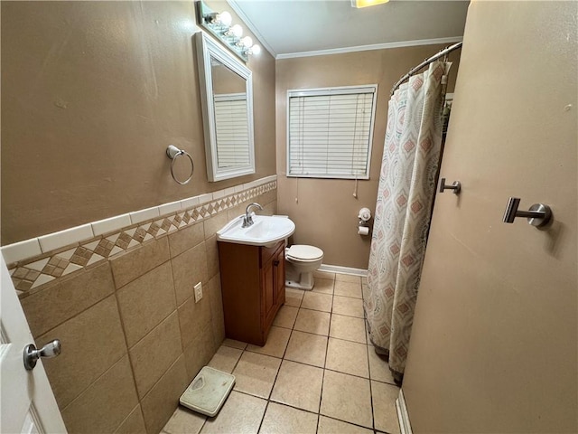 bathroom with tile patterned floors, ornamental molding, vanity, tile walls, and toilet