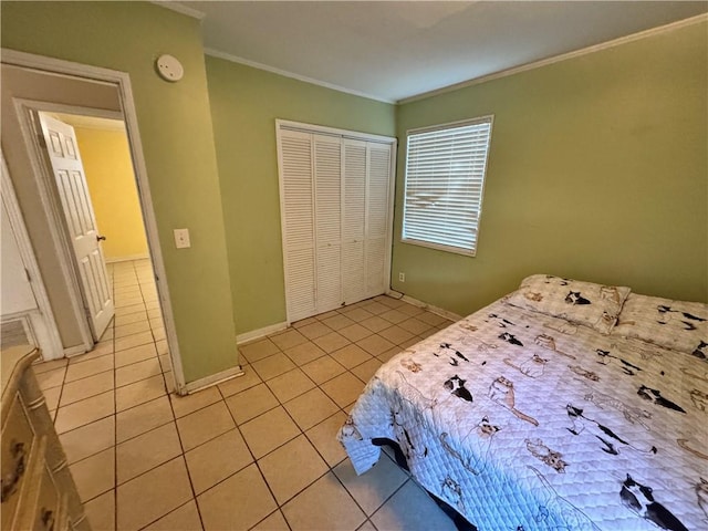 bedroom with a closet, ornamental molding, and light tile patterned flooring