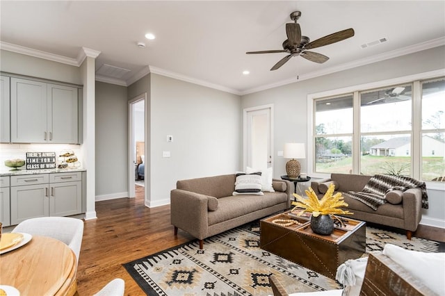 living room featuring dark wood-type flooring, ornamental molding, and ceiling fan